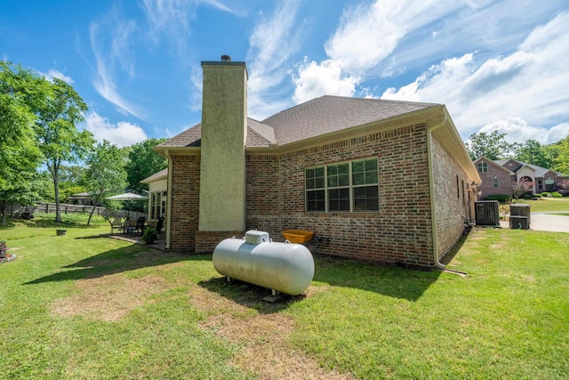 253 High Meadow Loop, Hot Springs, AR 71901 - back of house with brick siding, a chimney, central AC unit, and roof with shingles