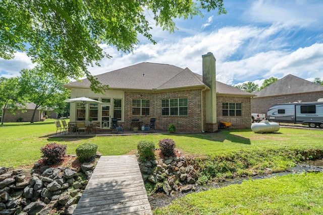 253 High Meadow Loop, Hot Springs, AR 71901 - back of house with brick siding, a chimney, a lawn, a patio area, and a shingled roof