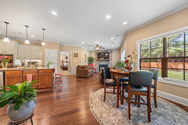 253 High Meadow Loop, Hot Springs, AR 71901 - dining room featuring a stone fireplace, ceiling fan, ornamental molding, recessed lighting, and dark wood finished floors