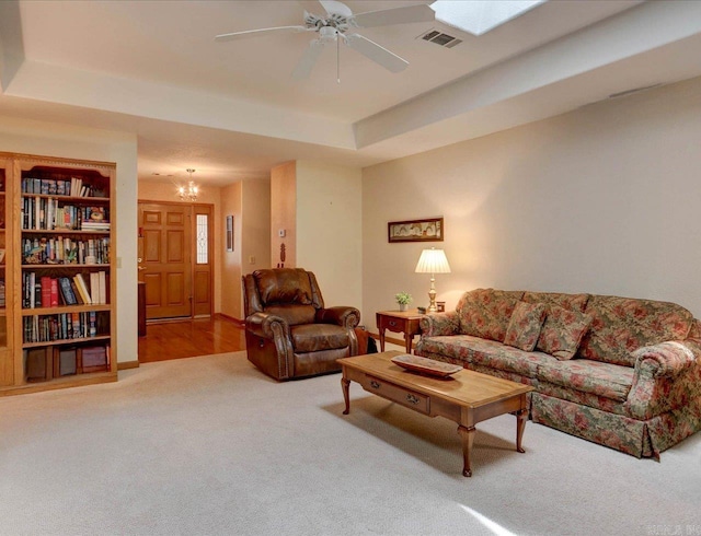 21 Conquista Ln, Hot Springs Village, AR 71909 - living area featuring carpet flooring, ceiling fan, a tray ceiling, and a chandelier