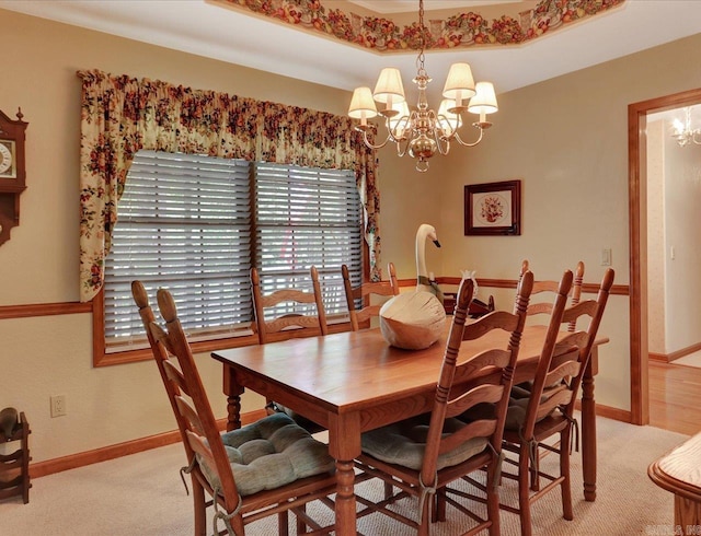 21 Conquista Ln, Hot Springs Village, AR 71909 - dining area featuring a chandelier, light colored carpet, and baseboards