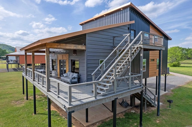 135 Serenity Loop, Glenwood, AR 71943 - rear view of house featuring stairs, a lawn, and a deck