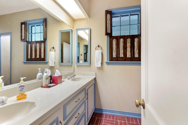 2424 N Fillmore St, Little Rock, AR 72207 - full bath featuring baseboards, brick patterned flooring, and double vanity