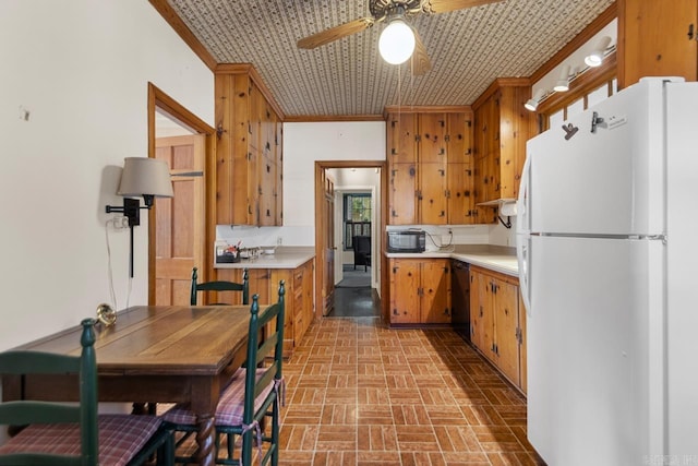 2424 N Fillmore St, Little Rock, AR 72207 - kitchen with black appliances, a ceiling fan, light countertops, brick patterned floors, and brown cabinetry