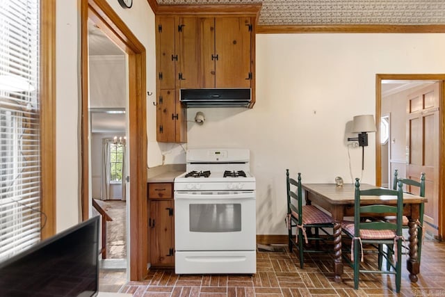 2424 N Fillmore St, Little Rock, AR 72207 - kitchen with white range with gas stovetop, ornamental molding, ventilation hood, brown cabinets, and baseboards