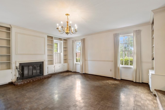 2424 N Fillmore St, Little Rock, AR 72207 - unfurnished living room featuring a chandelier, crown molding, a brick fireplace, built in features, and baseboards