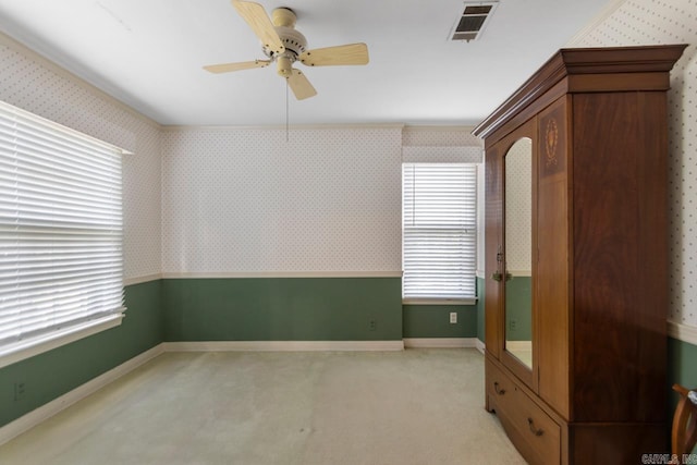 2424 N Fillmore St, Little Rock, AR 72207 - empty room with wallpapered walls, a ceiling fan, healthy amount of natural light, baseboards, and light colored carpet