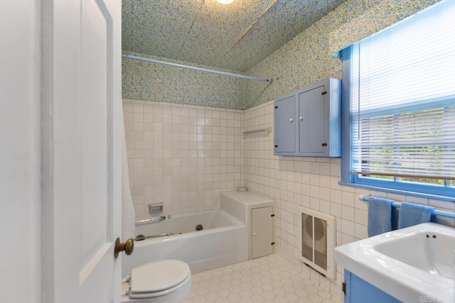 2424 N Fillmore St, Little Rock, AR 72207 - full bath with tile patterned floors, shower / bathtub combination, tile walls, vanity, and heating unit