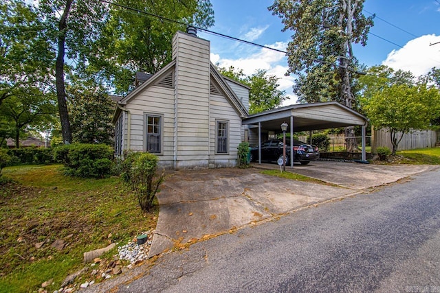 2424 N Fillmore St, Little Rock, AR 72207 - view of front facade with a chimney, fence, concrete driveway, and a detached carport