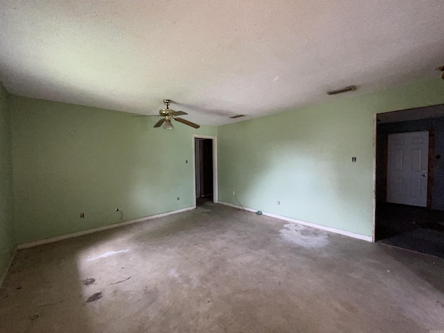 1602 Harmon Dr, Benton, AR 72015 - unfurnished room with baseboards, a ceiling fan, and a textured ceiling