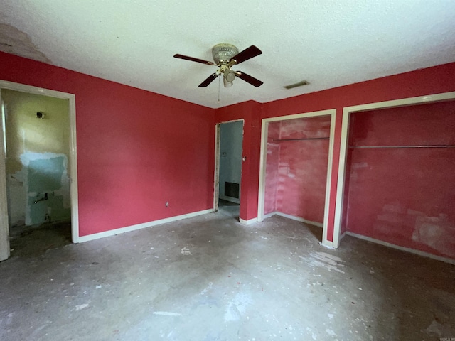 1602 Harmon Dr, Benton, AR 72015 - unfurnished bedroom with multiple closets, concrete floors, connected bathroom, a ceiling fan, and baseboards