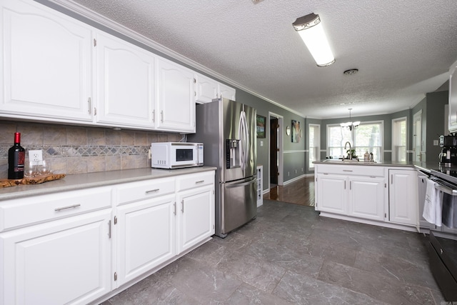 11 Blue Mountain Dr, Maumelle, AR 72113 - kitchen featuring white microwave, stainless steel refrigerator with ice dispenser, a textured ceiling, a chandelier, and decorative backsplash