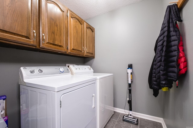 11 Blue Mountain Dr, Maumelle, AR 72113 - laundry area featuring cabinet space, separate washer and dryer, dark tile patterned flooring, baseboards, and a textured ceiling