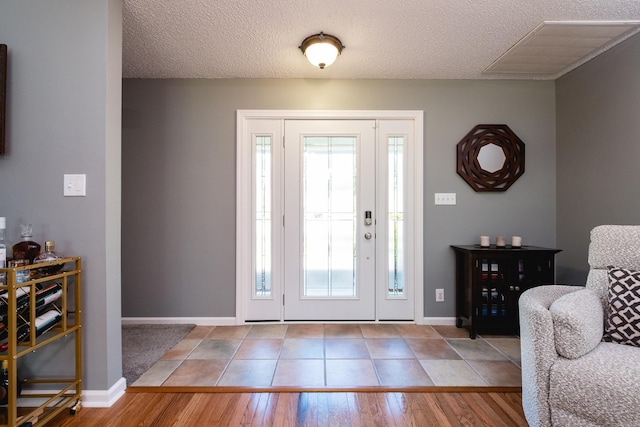 11 Blue Mountain Dr, Maumelle, AR 72113 - foyer entrance featuring plenty of natural light, baseboards, a textured ceiling, and wood finished floors