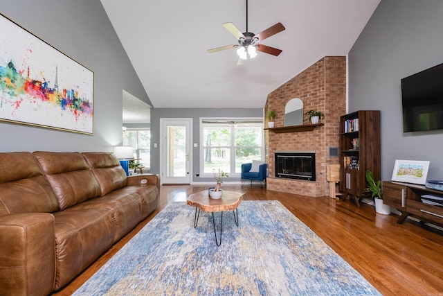 11 Blue Mountain Dr, Maumelle, AR 72113 - living room featuring high vaulted ceiling, wood finished floors, a ceiling fan, and a brick fireplace