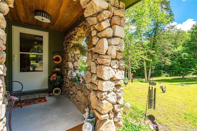 4915 Albert Pike Rd, Hot Springs, AR 71913 - view of exterior entry featuring a yard and stone siding