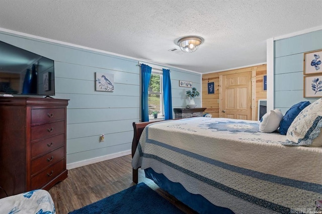 4915 Albert Pike Rd, Hot Springs, AR 71913 - bedroom featuring dark wood-style flooring, baseboards, a textured ceiling, and wooden walls