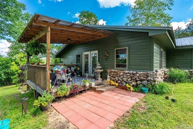 4915 Albert Pike Rd, Hot Springs, AR 71913 - back of house featuring a deck, a yard, and stone siding