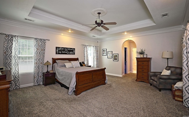 900 Anderson Ave, White Hall, AR 71602 - carpeted bedroom featuring arched walkways, a tray ceiling, ornamental molding, and baseboards