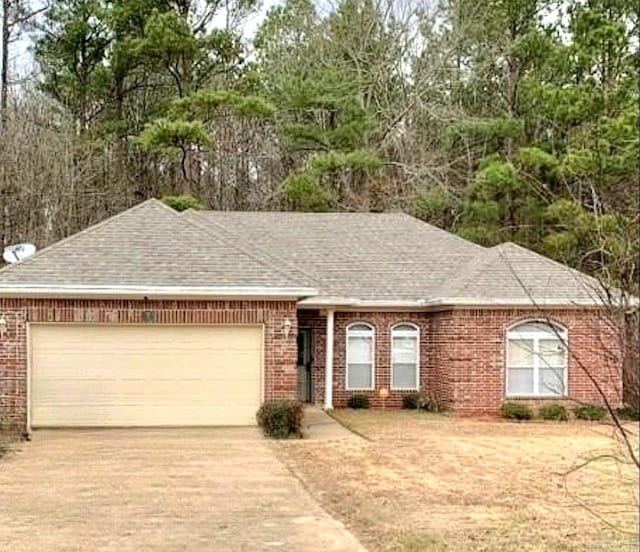8 Tombstone Ct, Little Rock, AR 72209 - single story home with a garage, concrete driveway, brick siding, and a shingled roof