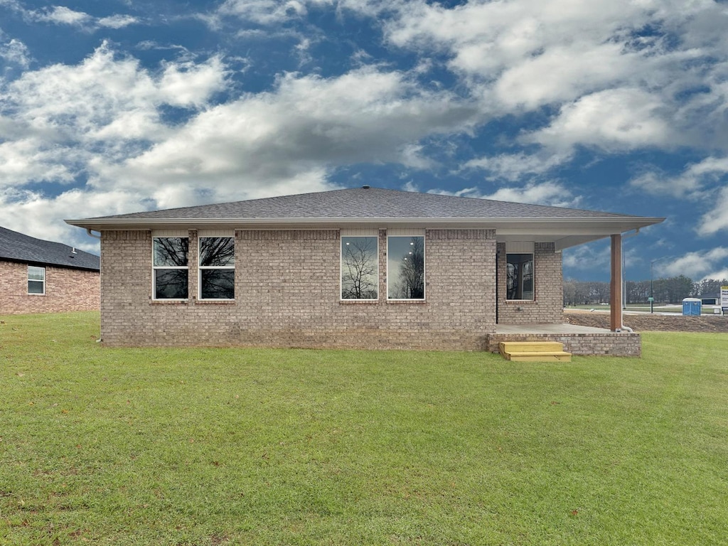 1513 Ridgefield Cir, Searcy, AR 72143 - back of property with brick siding, a lawn, and a shingled roof