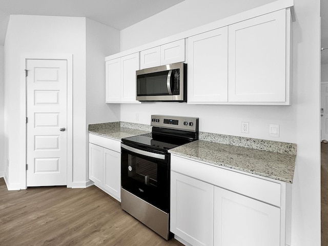 1513 Ridgefield Cir, Searcy, AR 72143 - kitchen featuring appliances with stainless steel finishes, light wood-style flooring, white cabinets, and light stone counters