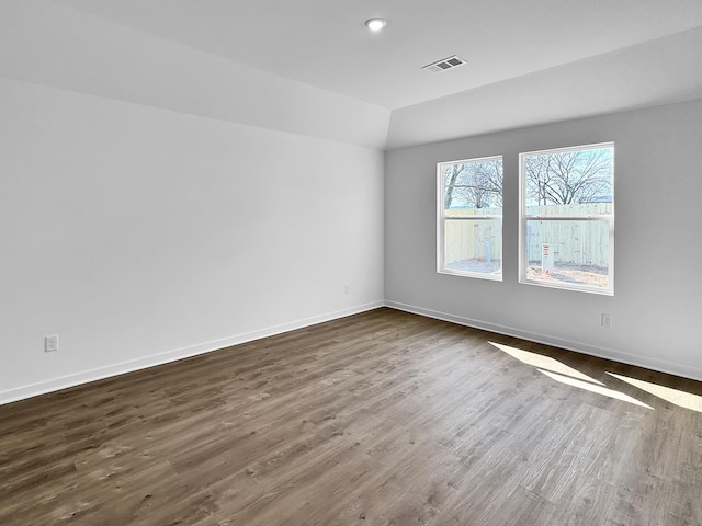 1513 Ridgefield Cir, Searcy, AR 72143 - empty room featuring dark wood-type flooring, baseboards, and lofted ceiling