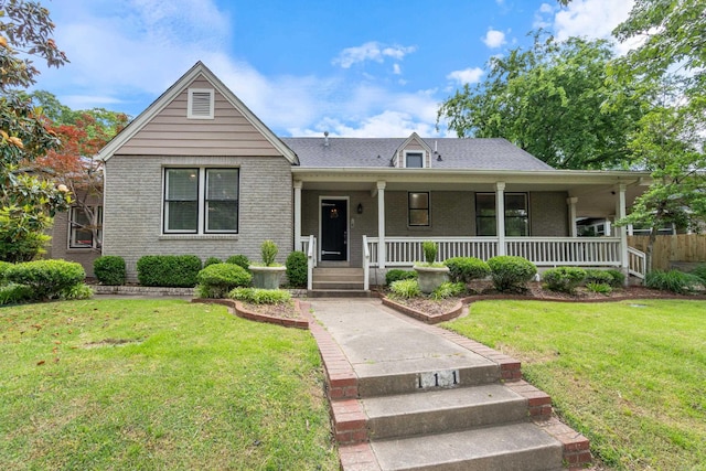 111 Midland St, Little Rock, AR 72205 - view of front of home with brick siding, covered porch, and a front yard