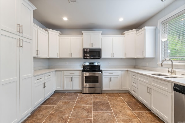 111 Midland St, Little Rock, AR 72205 - kitchen featuring stainless steel appliances, a sink, white cabinetry, light countertops, and recessed lighting