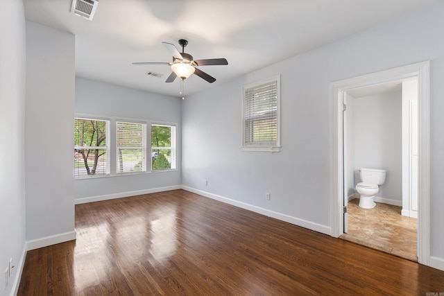 111 Midland St, Little Rock, AR 72205 - unfurnished bedroom with multiple windows, dark wood finished floors, and baseboards