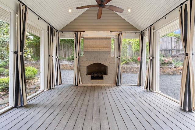 111 Midland St, Little Rock, AR 72205 - unfurnished sunroom with an outdoor brick fireplace, vaulted ceiling, a ceiling fan, and a water view