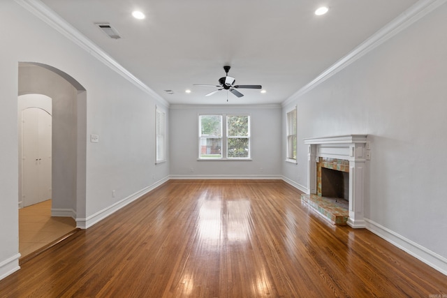 111 Midland St, Little Rock, AR 72205 - unfurnished living room with a ceiling fan, wood finished floors, crown molding, a fireplace, and arched walkways