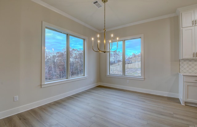 173 Maumelle Valley Dr, Maumelle, AR 72113 - unfurnished dining area with a chandelier, ornamental molding, healthy amount of natural light, light wood finished floors, and baseboards