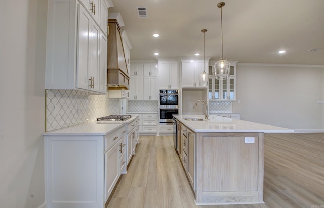 173 Maumelle Valley Dr, Maumelle, AR 72113 - kitchen featuring a sink, appliances with stainless steel finishes, light wood-style flooring, decorative backsplash, and light countertops