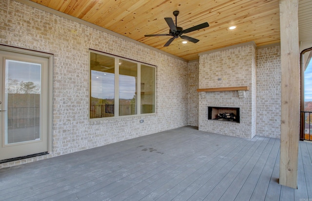 173 Maumelle Valley Dr, Maumelle, AR 72113 - unfurnished living room with wooden ceiling, ceiling fan, wood finished floors, an outdoor brick fireplace, and brick wall