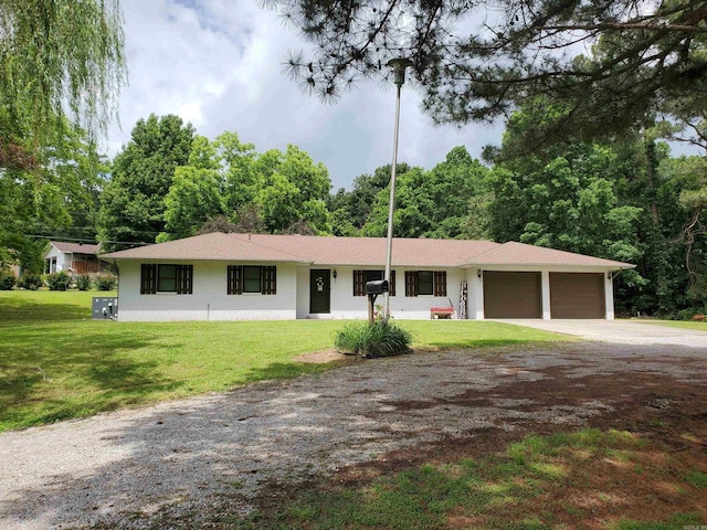 800 Hilltop Dr, Piggott, AR 72454 - single story home with dirt driveway, a garage, and a front yard