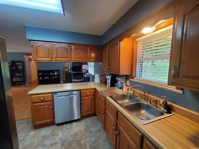 800 Hilltop Dr, Piggott, AR 72454 - kitchen with dishwasher, a sink, light countertops, and brown cabinets