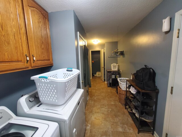 800 Hilltop Dr, Piggott, AR 72454 - clothes washing area featuring cabinet space, washer and dryer, and a textured ceiling