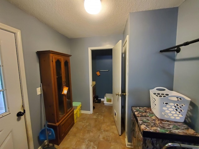 800 Hilltop Dr, Piggott, AR 72454 - mudroom featuring a textured ceiling