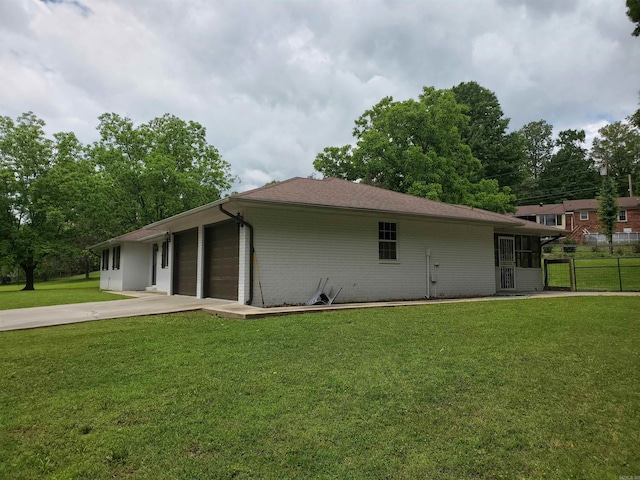 800 Hilltop Dr, Piggott, AR 72454 - rear view of property featuring a garage and concrete driveway