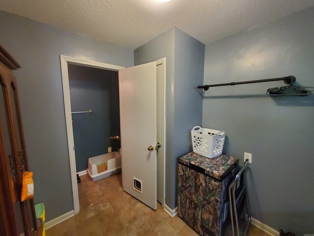 800 Hilltop Dr, Piggott, AR 72454 - corridor with baseboards and a textured ceiling