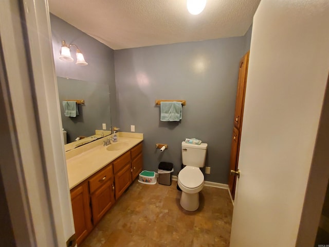 800 Hilltop Dr, Piggott, AR 72454 - bathroom with toilet, a textured ceiling, and vanity