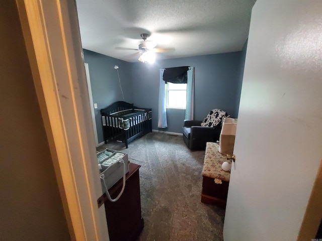 800 Hilltop Dr, Piggott, AR 72454 - bedroom featuring a crib, dark colored carpet, and a ceiling fan