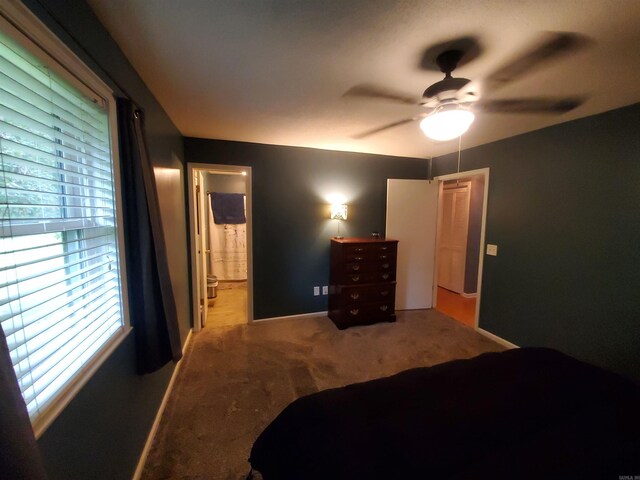 800 Hilltop Dr, Piggott, AR 72454 - carpeted bedroom featuring baseboards, ceiling fan, and connected bathroom