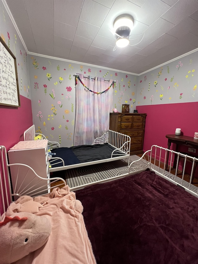 bedroom featuring crown molding and wallpapered walls
