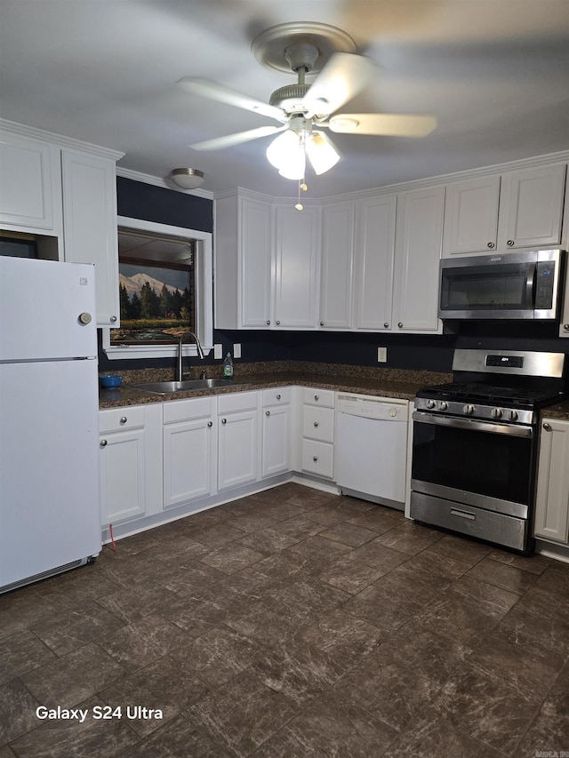 kitchen featuring stainless steel appliances, a sink, white cabinetry, and a ceiling fan