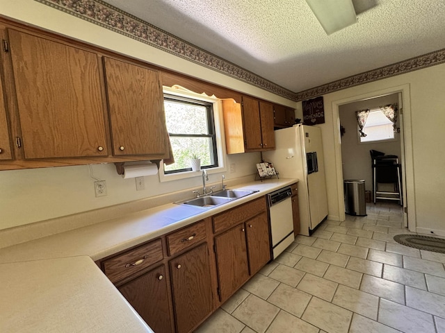 7 Minentonka Dr, Cherokee Village, AR 72529 - kitchen featuring a sink, white dishwasher, light countertops, a textured ceiling, and brown cabinets