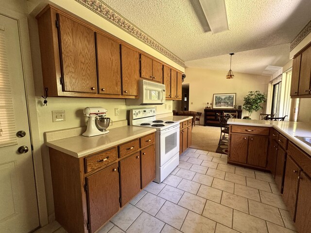 7 Minentonka Dr, Cherokee Village, AR 72529 - kitchen with white appliances, a textured ceiling, light countertops, brown cabinets, and hanging light fixtures