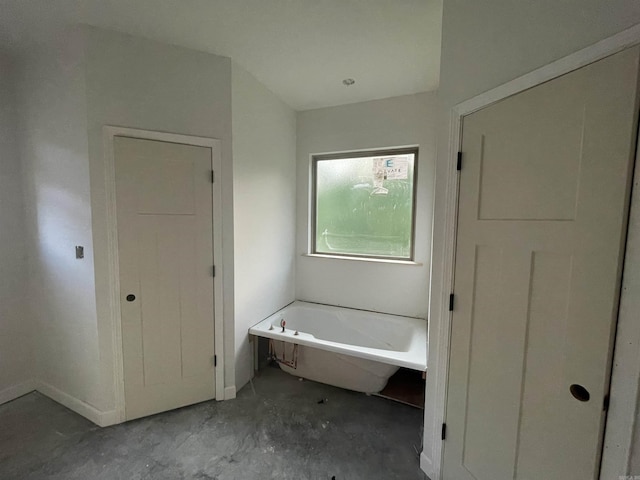 25 Mountain Grove Rd, Greenbrier, AR 72058 - bathroom with a freestanding bath, unfinished concrete flooring, and baseboards