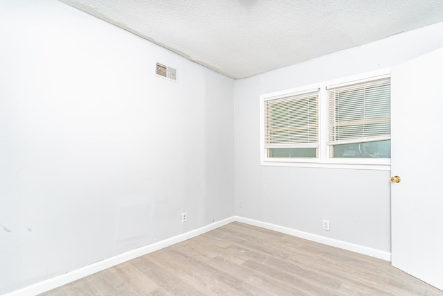306 N 35th St, West Memphis, AR 72301 - spare room with light wood-type flooring, a textured ceiling, and baseboards